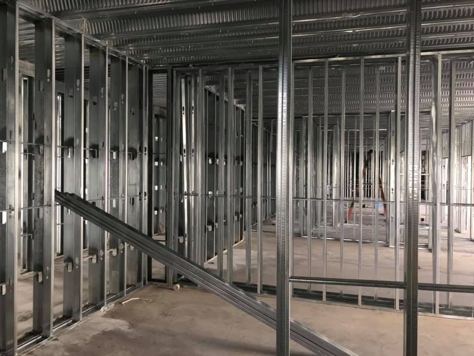 The inside of a building under construction with a lot of metal frames.