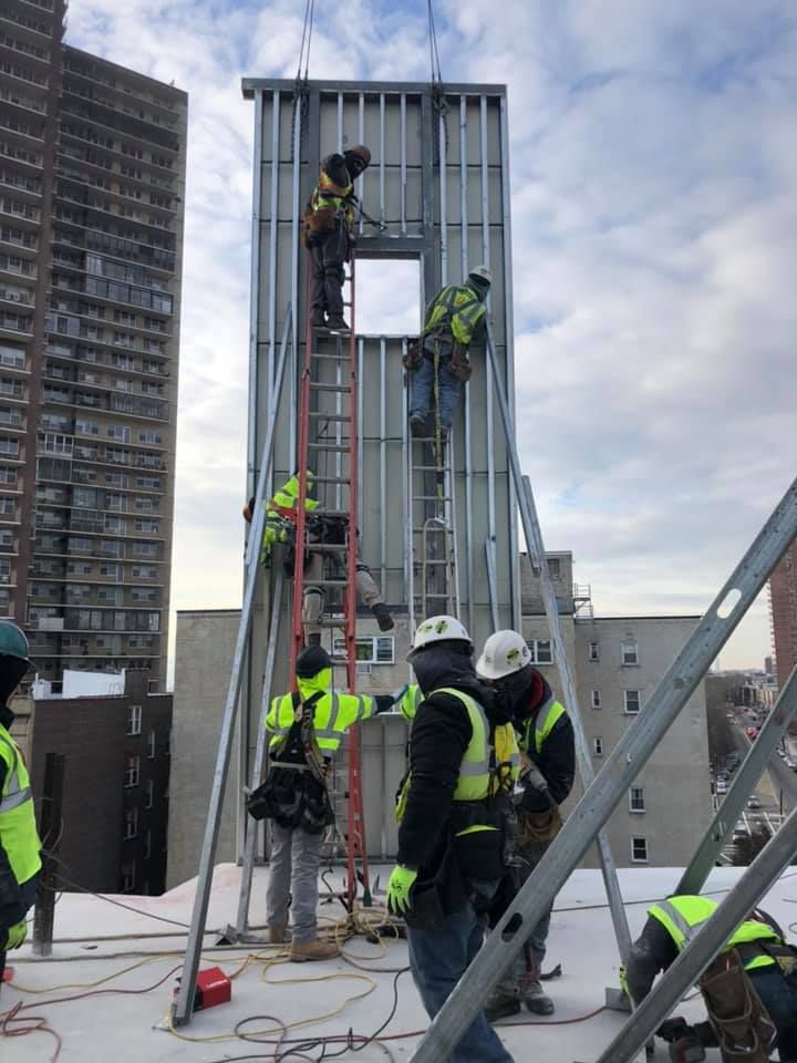 A group of construction workers are working on a building