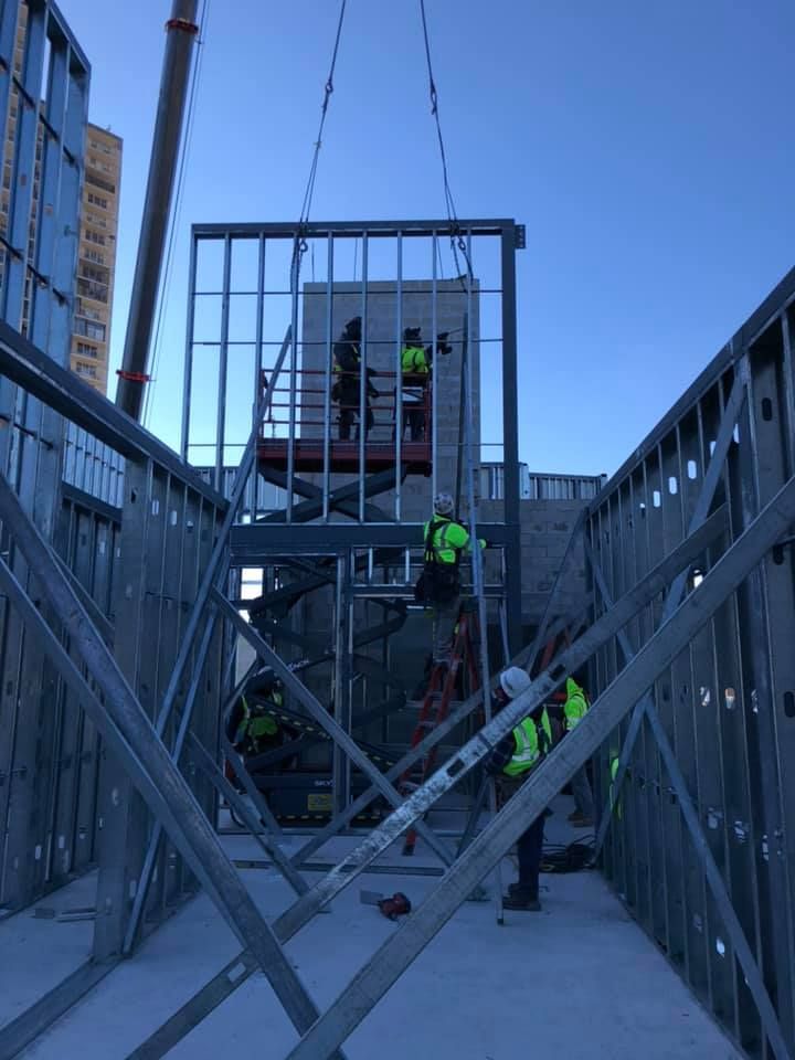 A group of construction workers are working on a building.