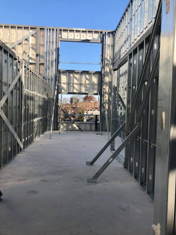 A building under construction with a large window in the middle