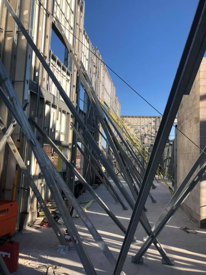 A large metal structure is being built on the side of a building.