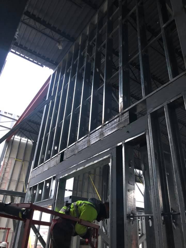 A construction worker is working on a building under construction.