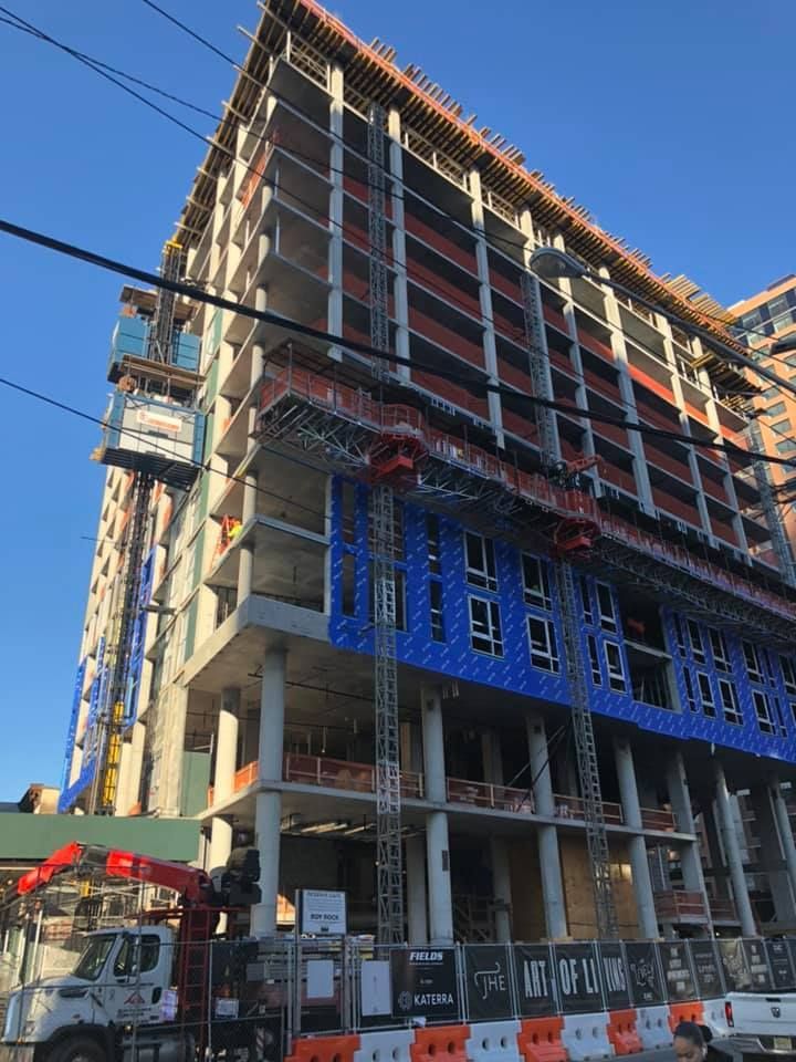 A large building under construction with a truck parked in front of it
