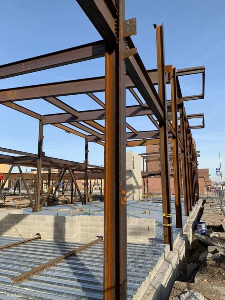 A building under construction with a blue sky in the background