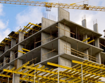 A large building under construction with a crane in the background