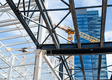 A building under construction with a crane in the background.
