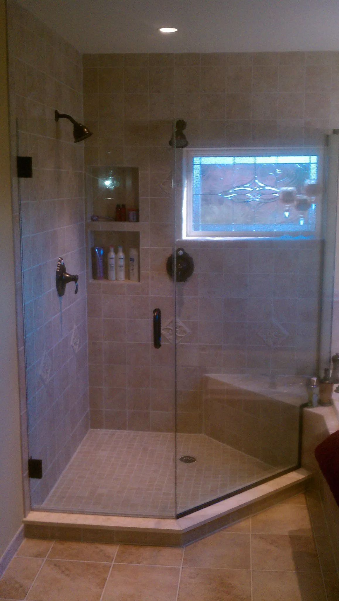 A bathroom with a sliding glass shower door and a toilet.