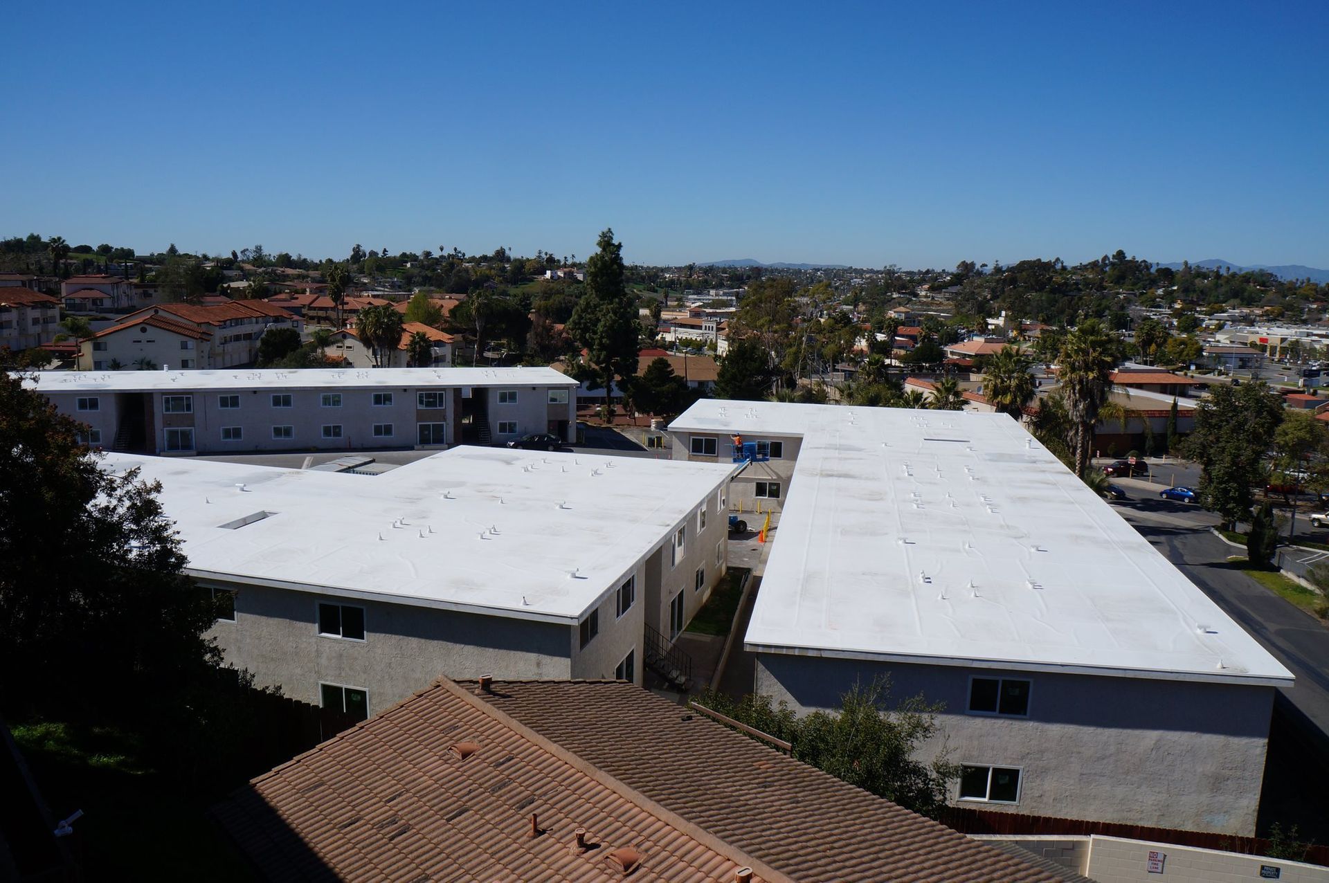 An aerial view of a building with a white roof