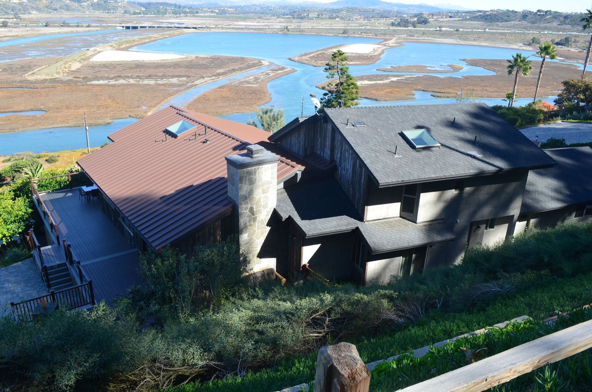 A house on a hill overlooking a body of water