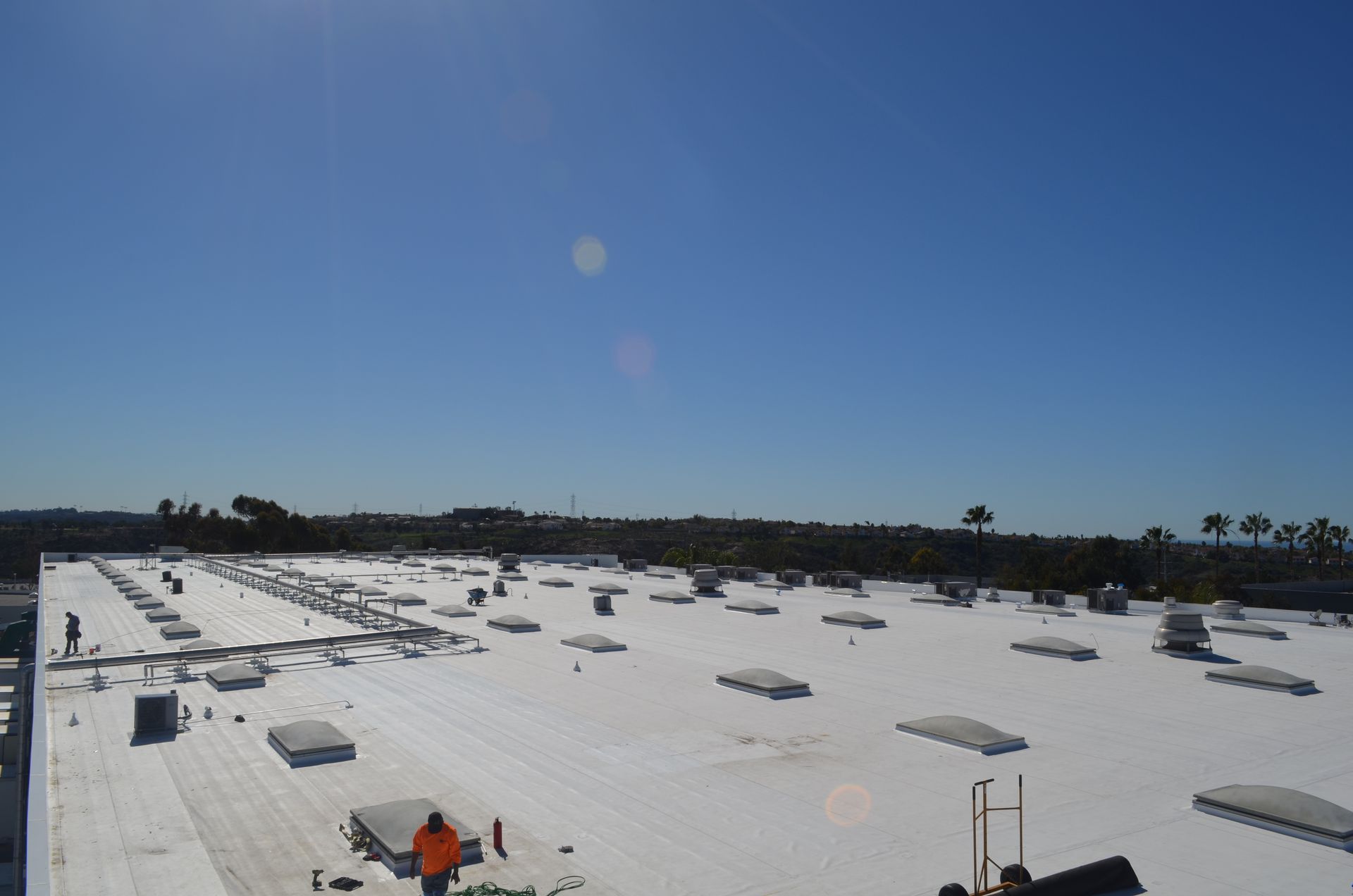 A large white roof with a blue sky in the background
