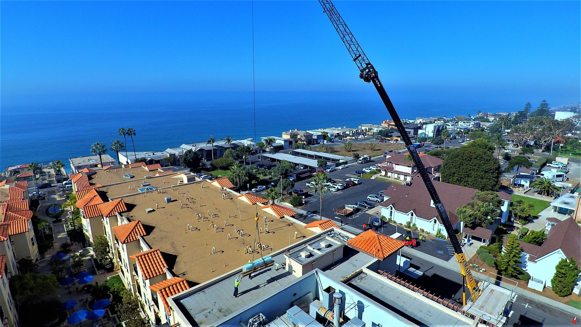 An aerial view of a large building with a crane on top of it.