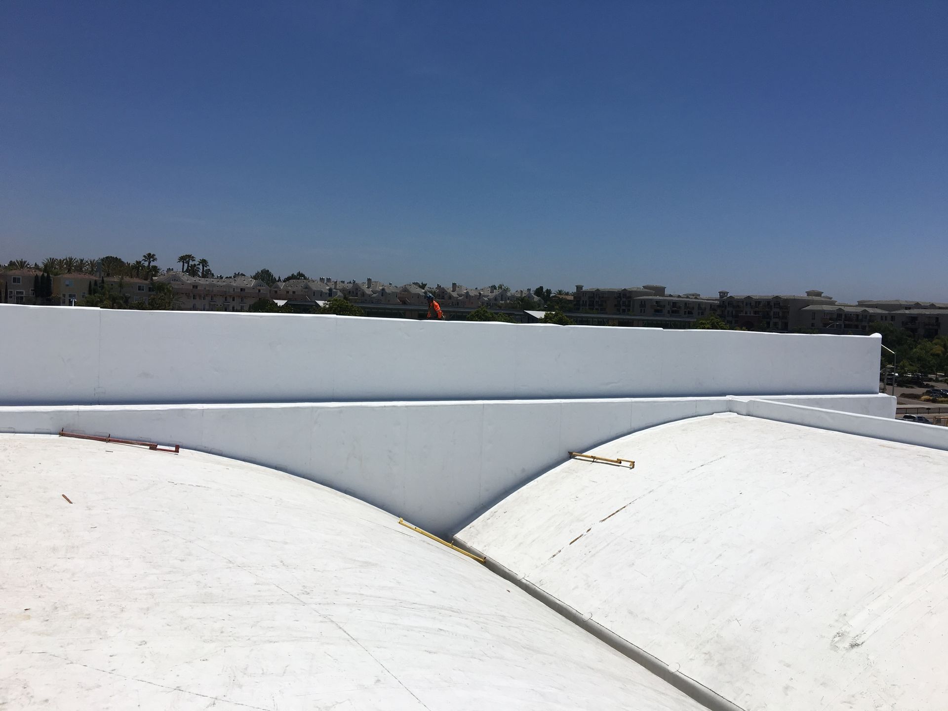 A white dome roof with a blue sky in the background.
