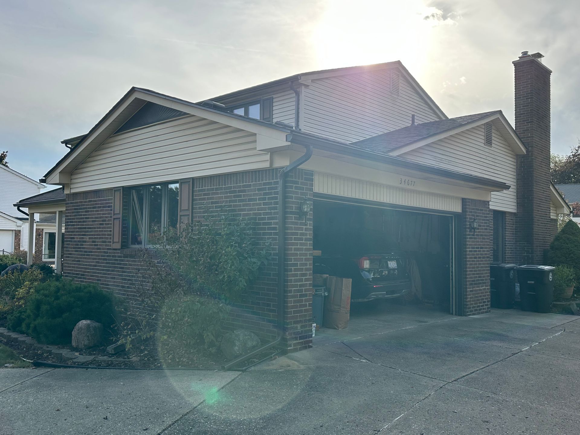 Two-story house with brick and siding, a two-car garage, and a driveway.