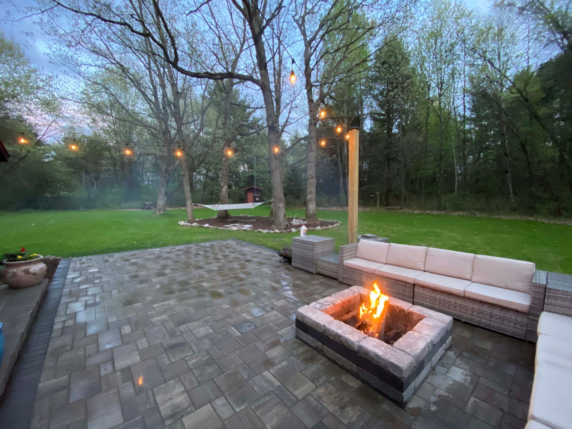 There is a fire pit in the middle of the patio.