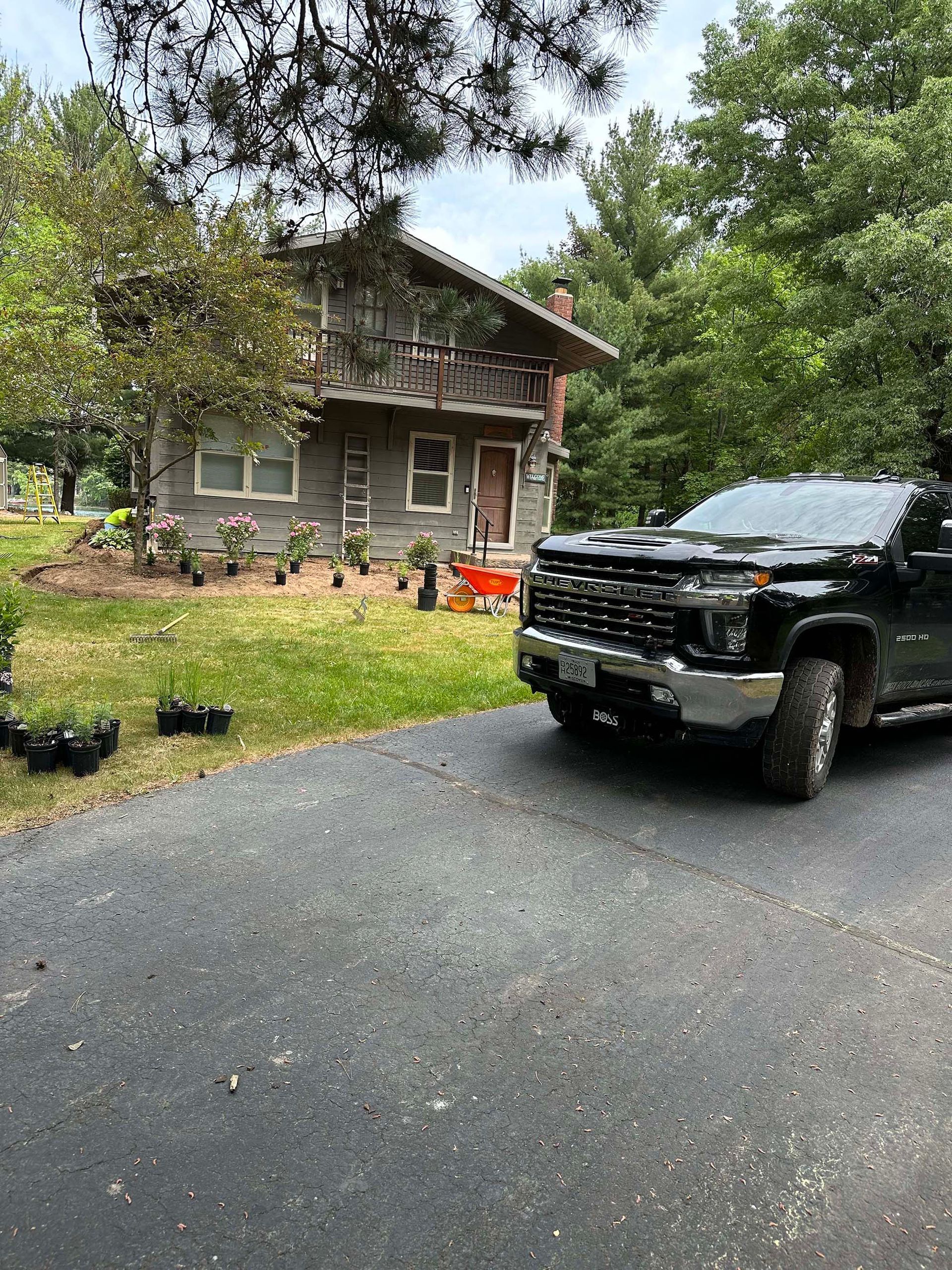 A black truck is parked in front of a house.