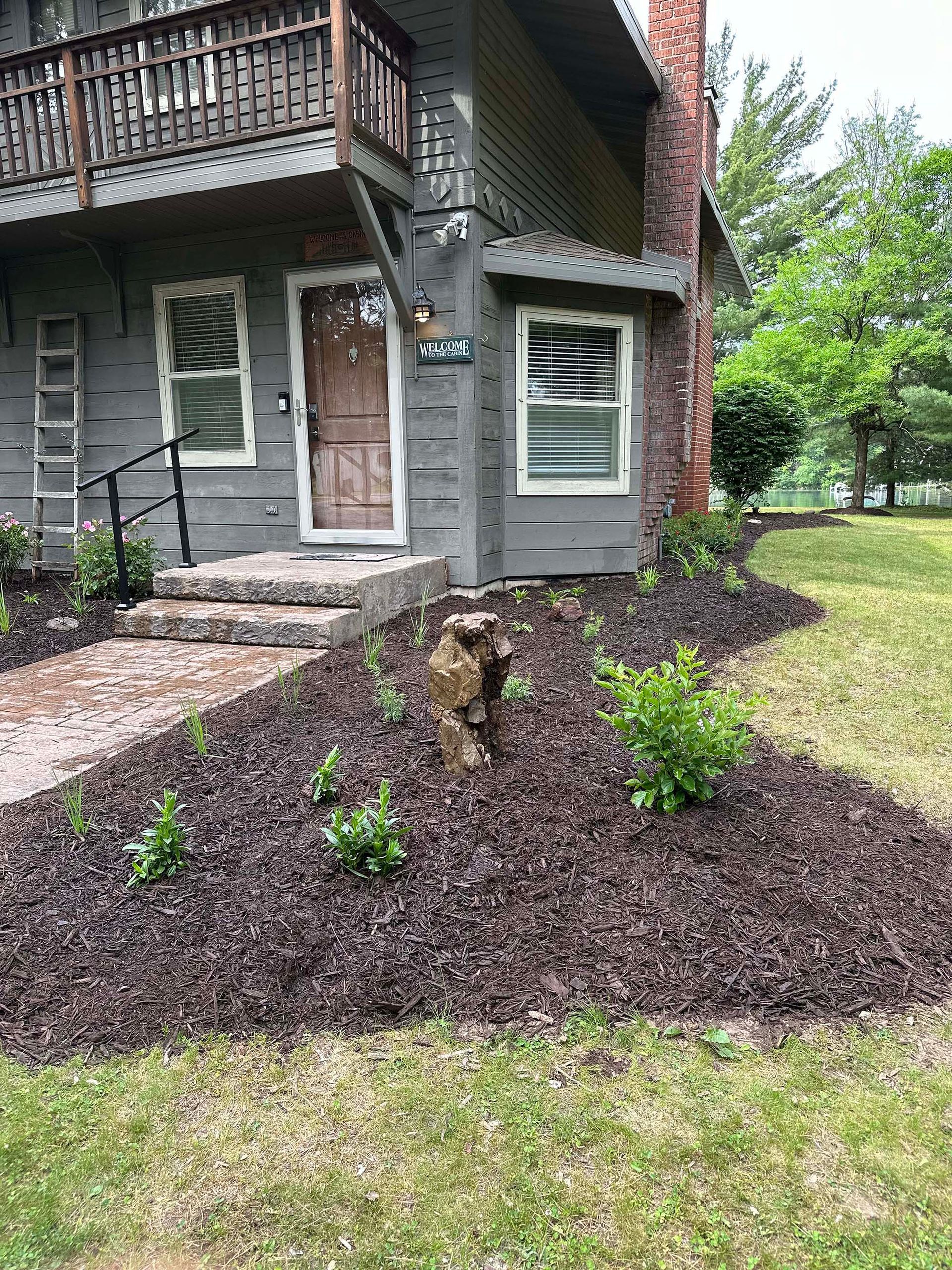 A dog is standing in front of a house.