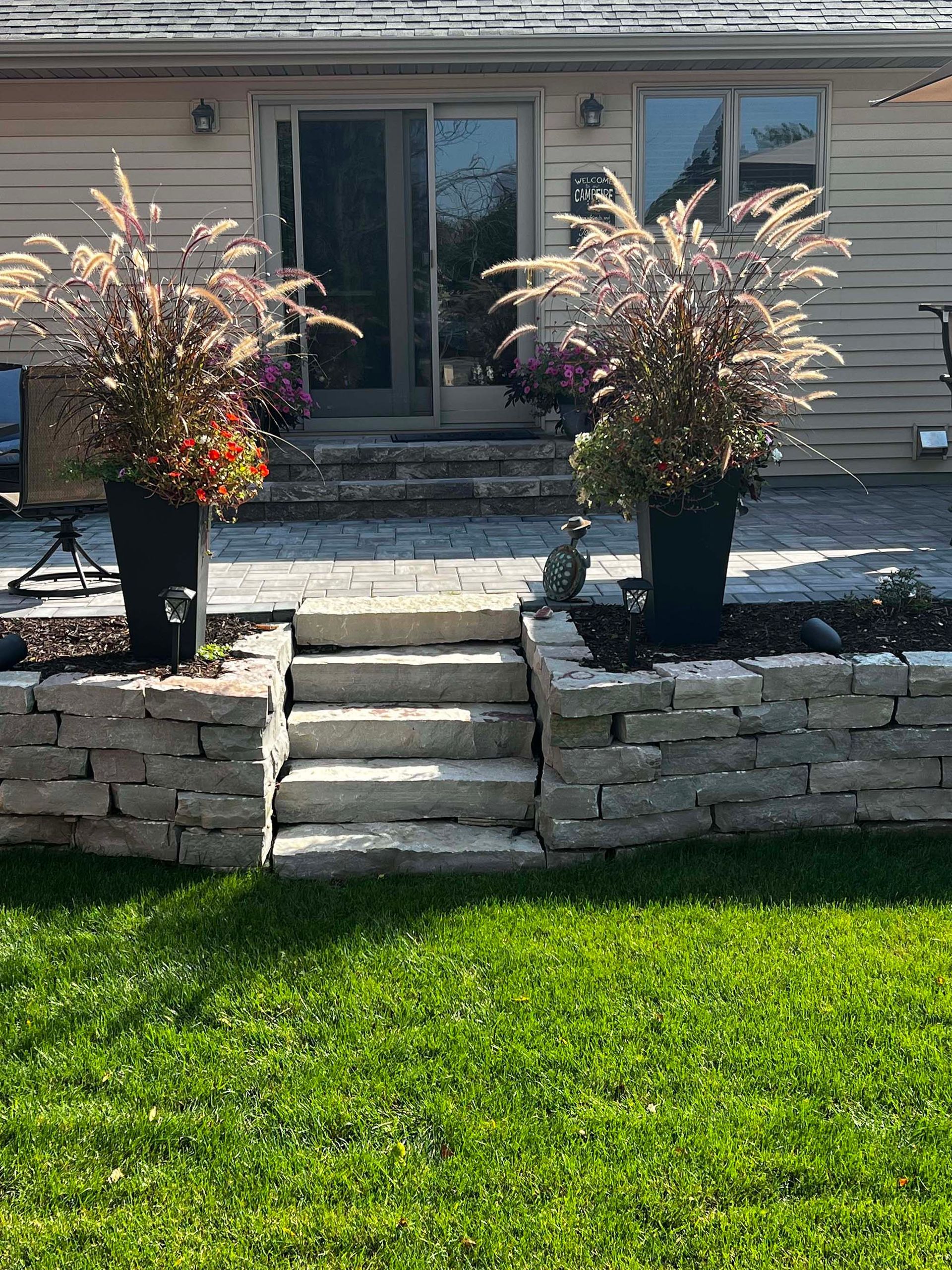 A house with a patio and stairs in front of it.