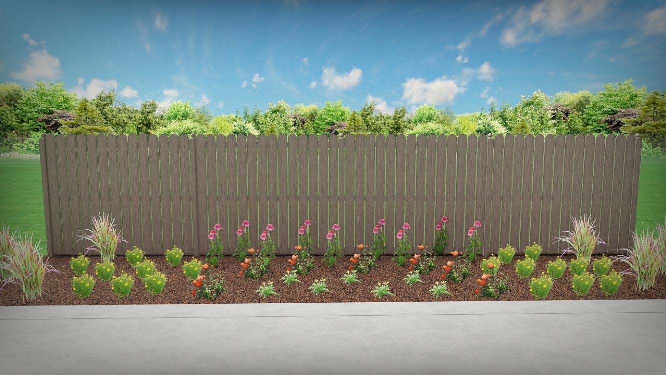 A wooden fence surrounded by flowers and bushes on a sidewalk.