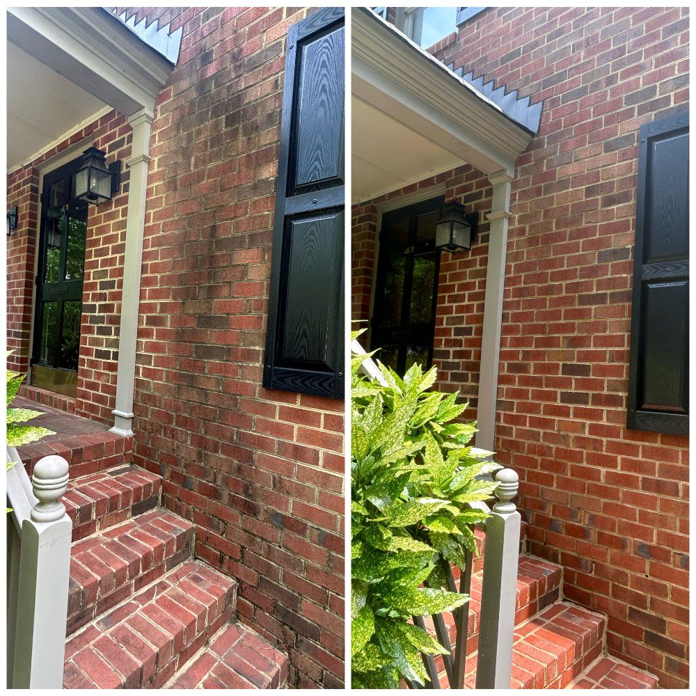 Side-by-side view: Brick home before and after cleaning. The left side is stained, the right side is clean.