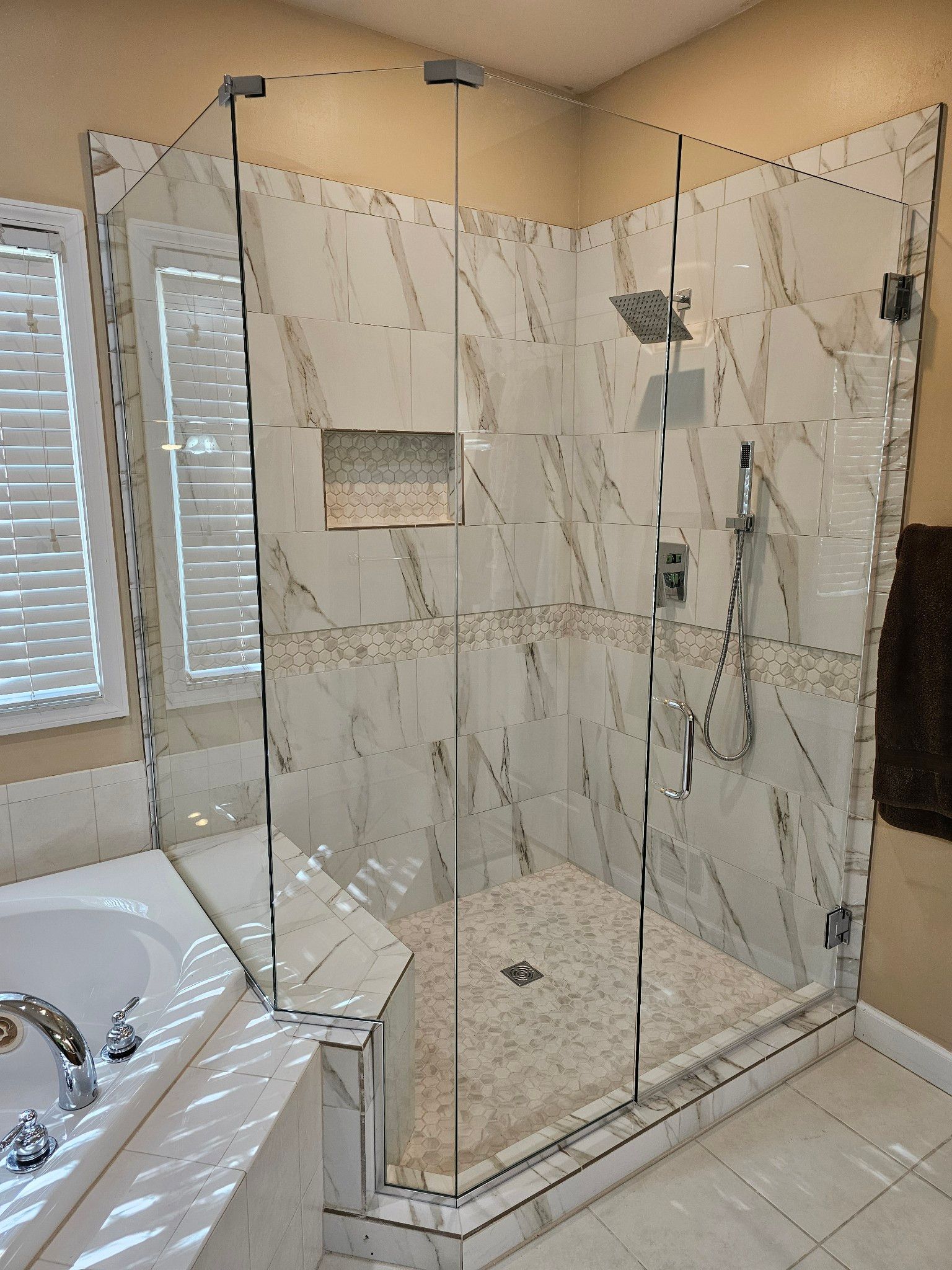 A bathroom with a walk in shower and a bathtub.