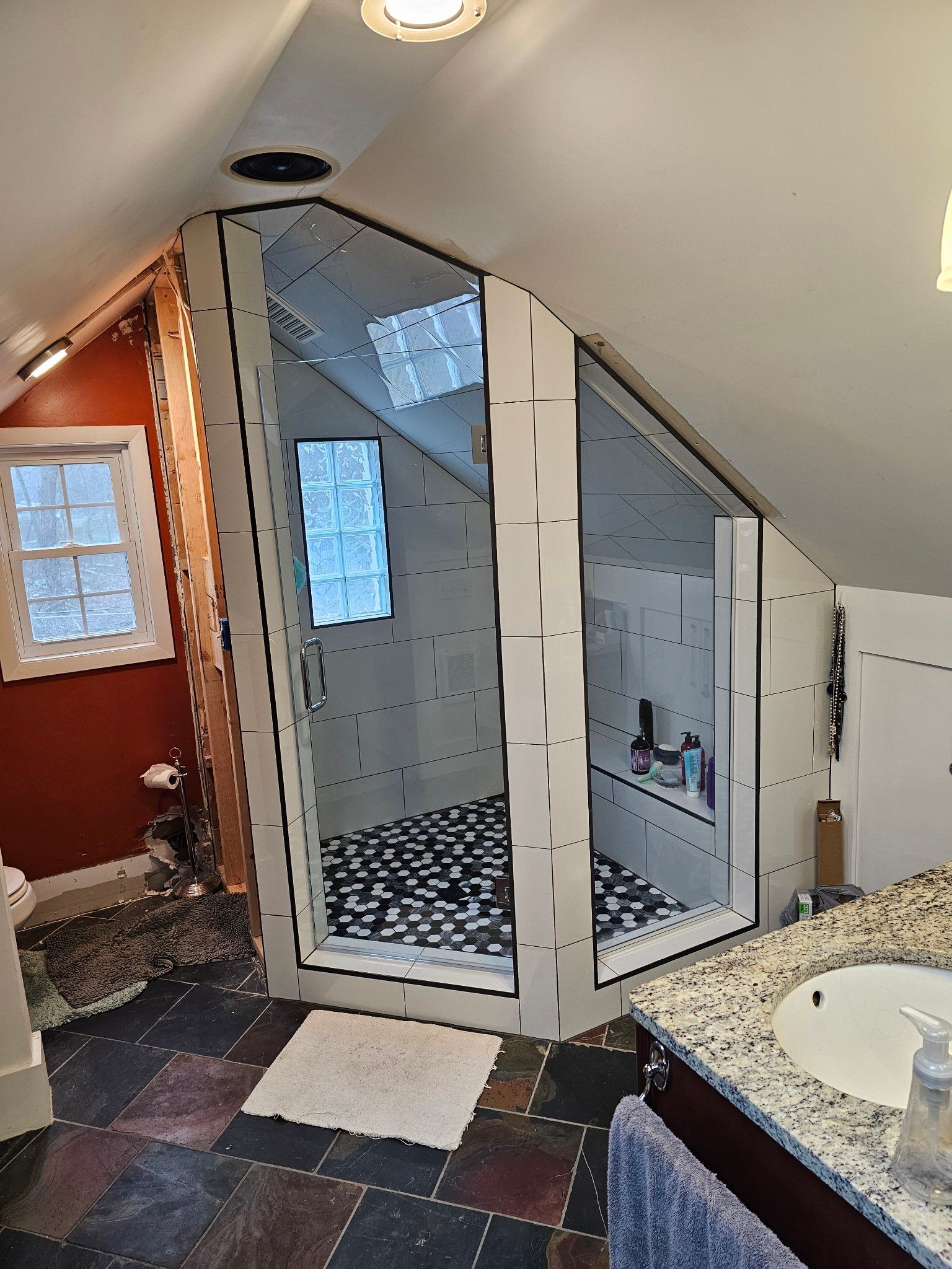 A bathroom with a shower being built in the attic