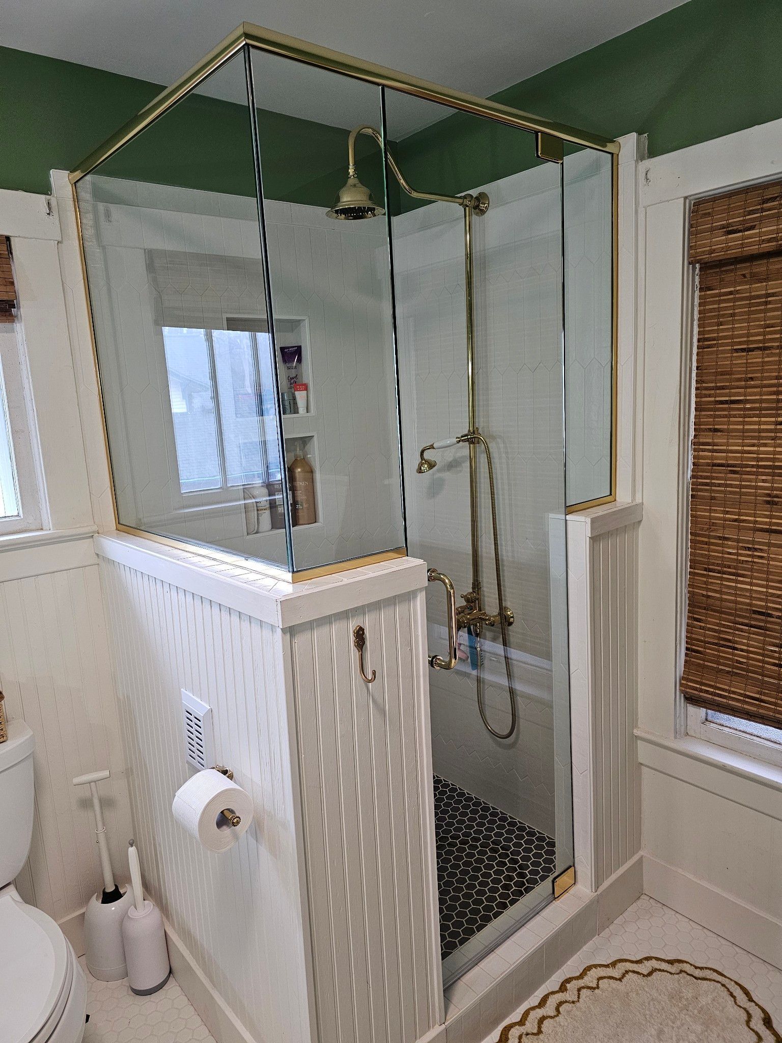 A bathroom with a walk in shower and a toilet.