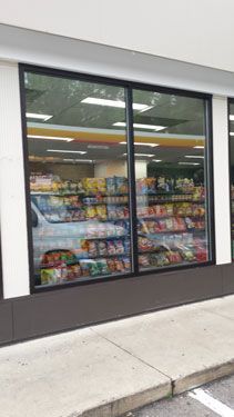 A convenience store with a lot of food in the window.