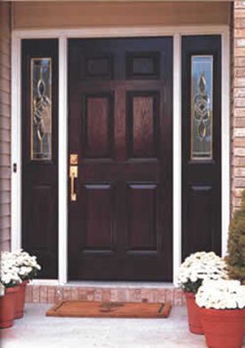 A front door with flowers in pots in front of it