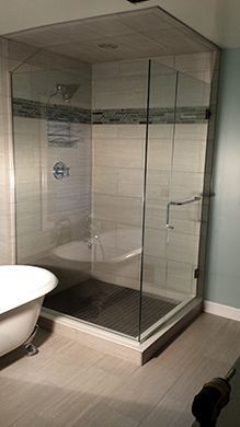 A bathroom with a bathtub and a walk in shower.