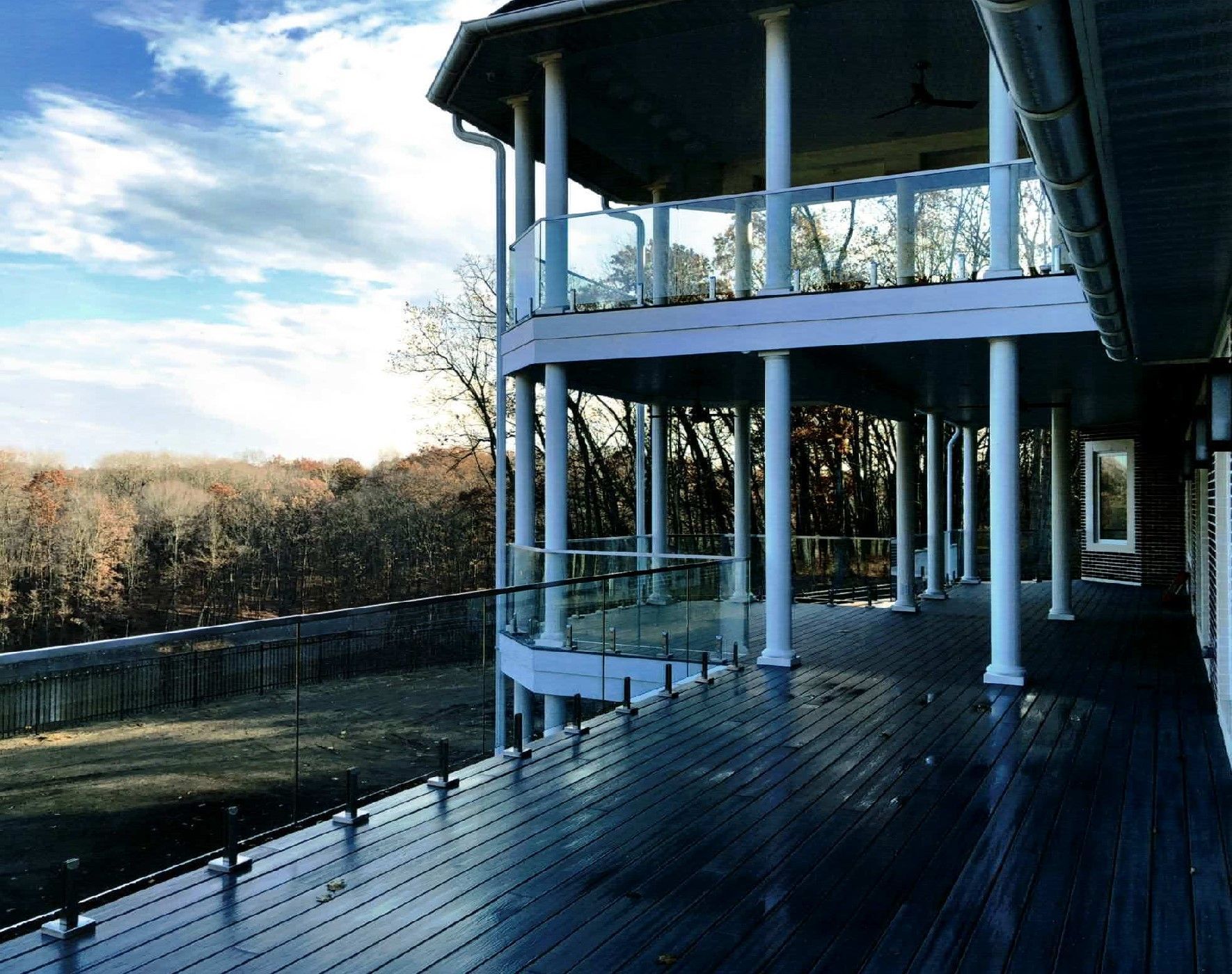 A large deck with a view of a forest