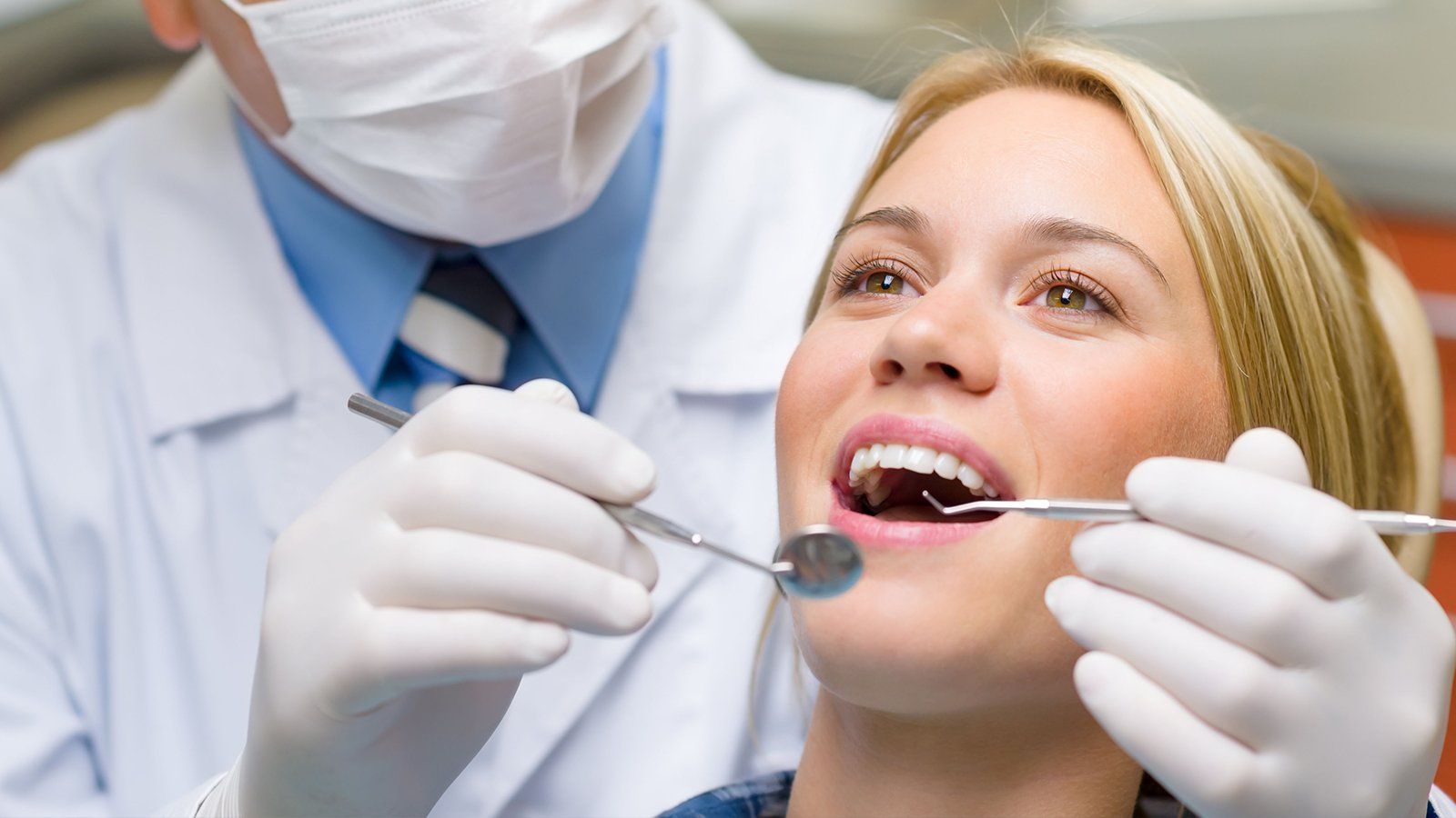 Checking woman's teeth