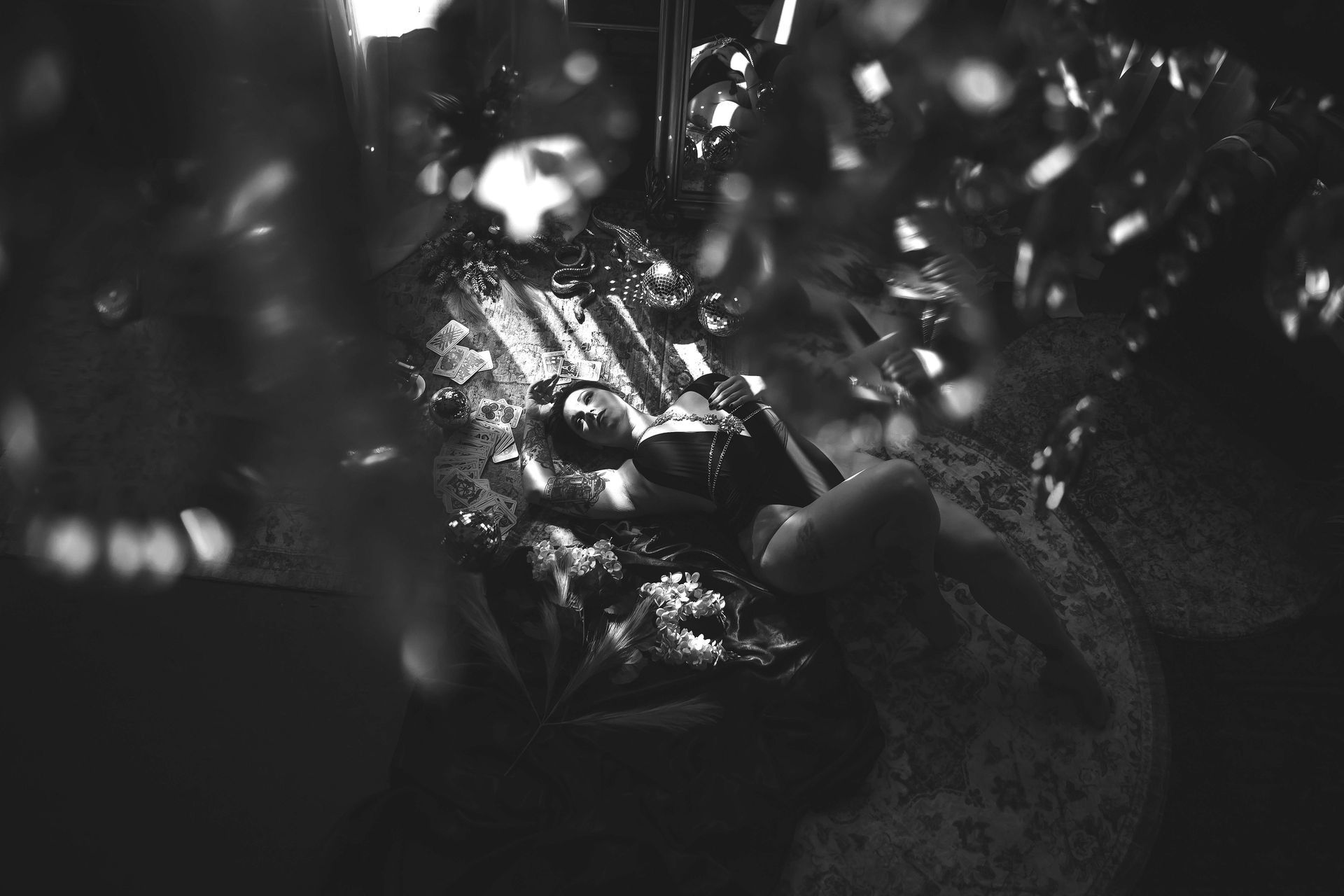 A person in a reflective environment, possibly inside a machine or enclosure, with highlights and shadows.