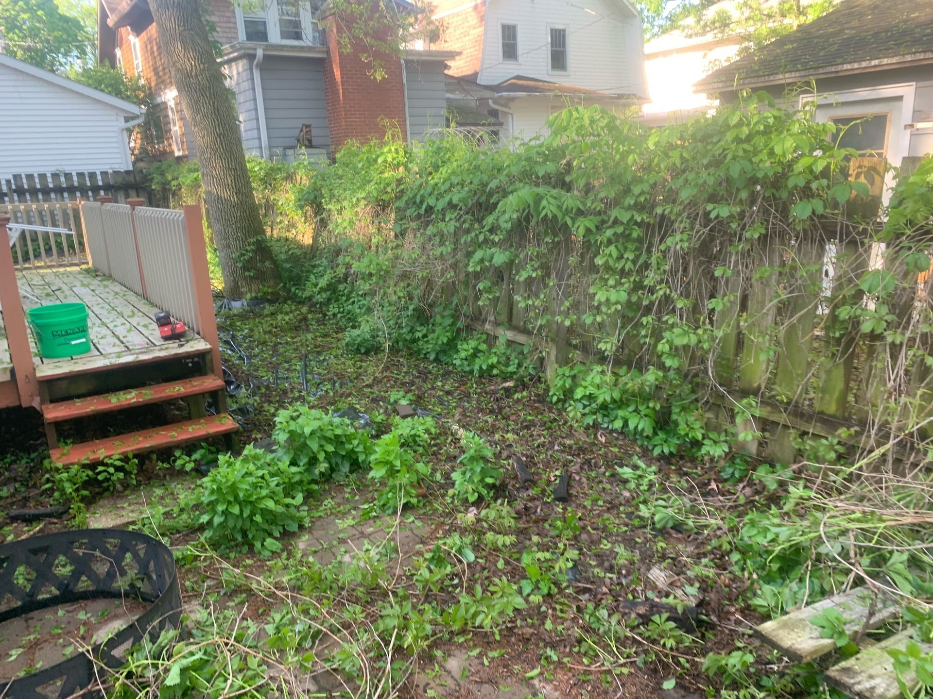 A wooden fence is in the backyard of a house.