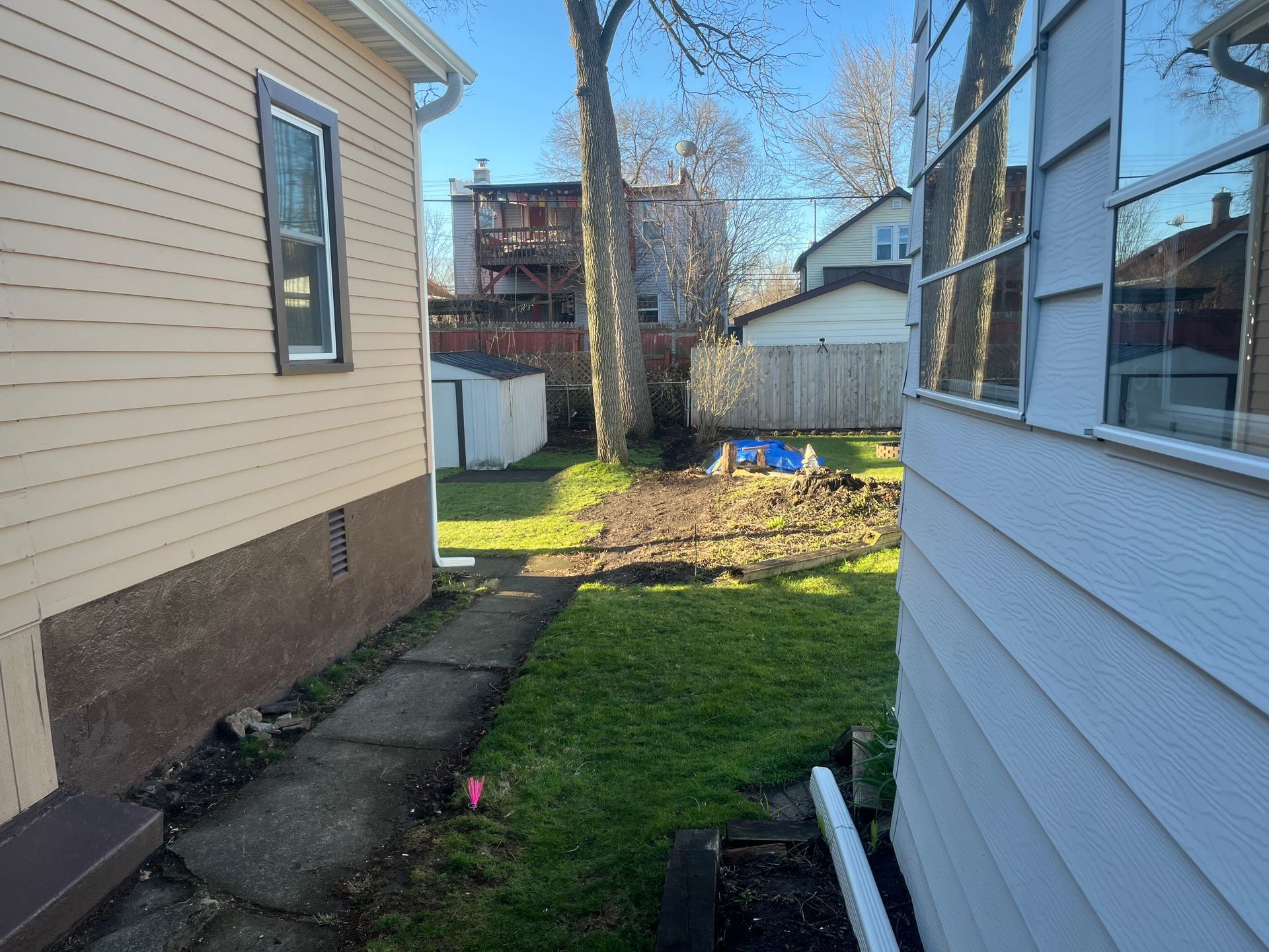 A house with a walkway leading to the backyard