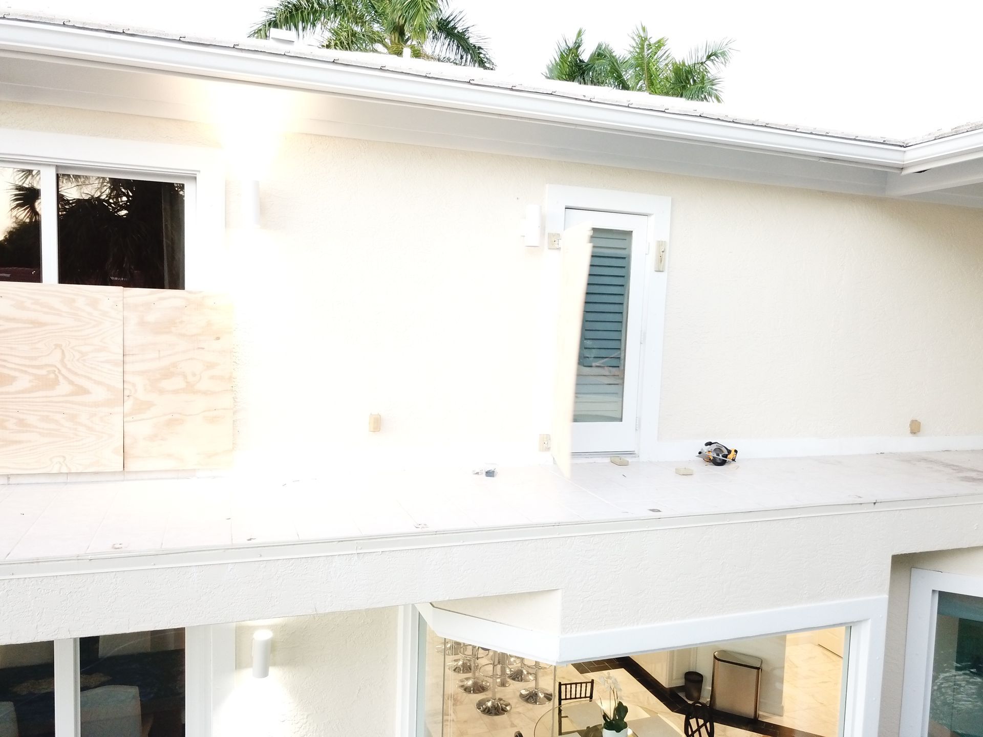 A white house with a staircase leading up to the second floor.