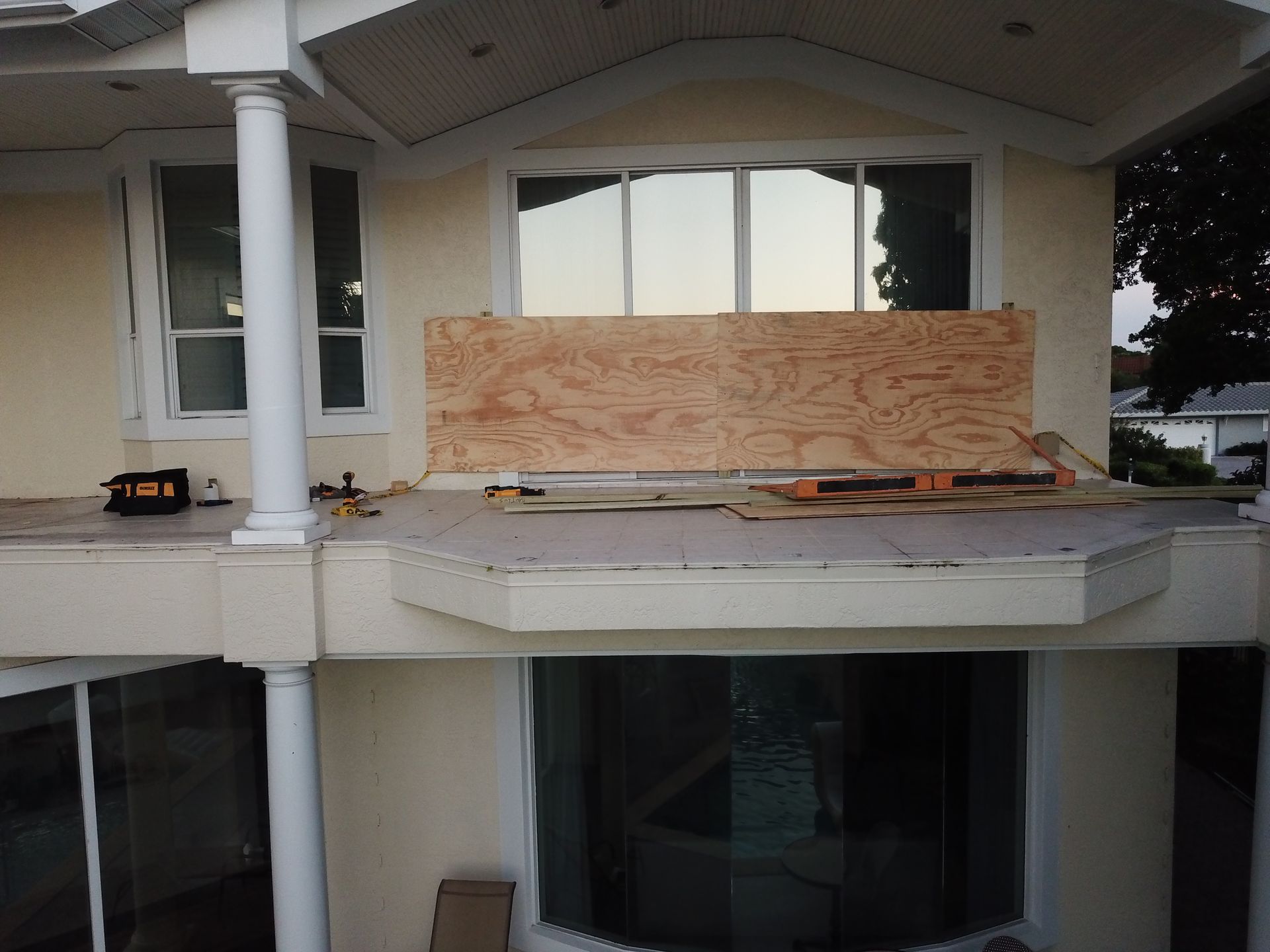 A house with a boarded up window and a balcony