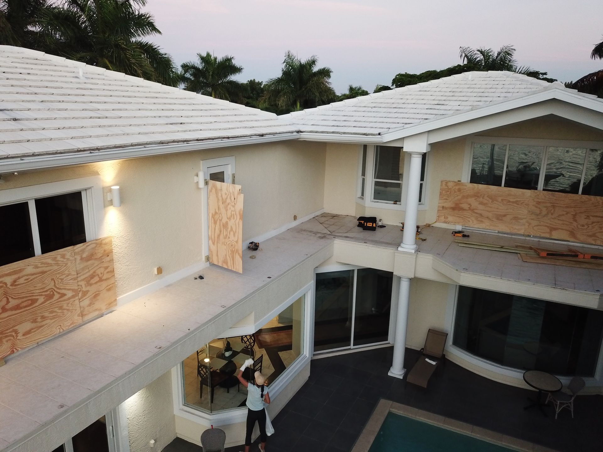 An aerial view of a house that has been damaged by a hurricane.