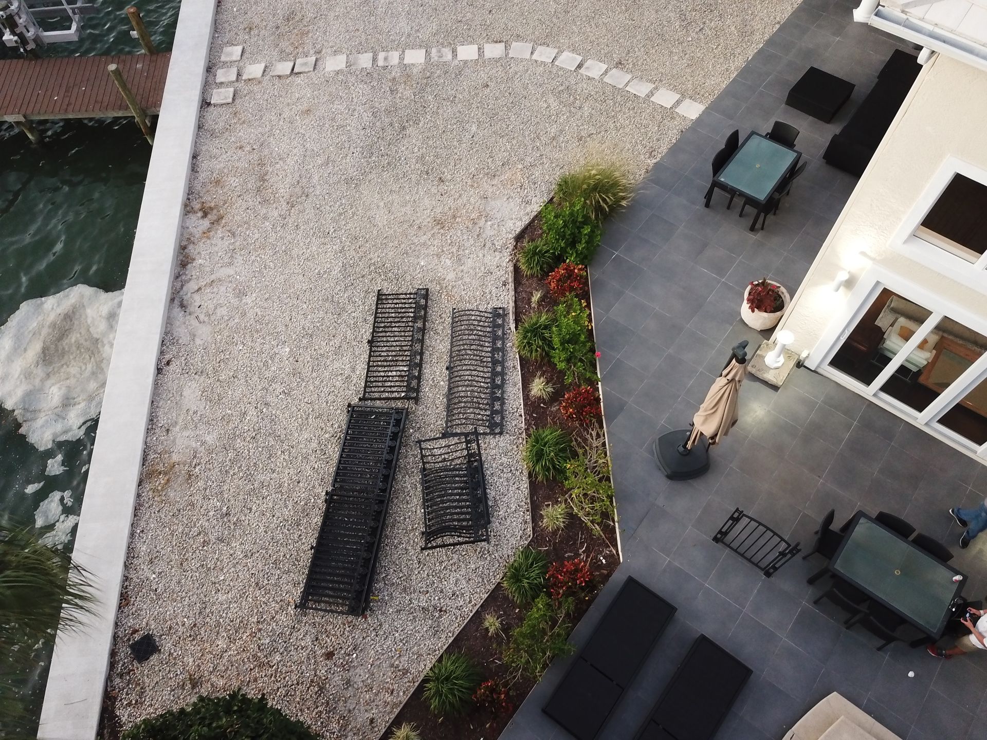 An aerial view of a patio with chairs tables and umbrellas