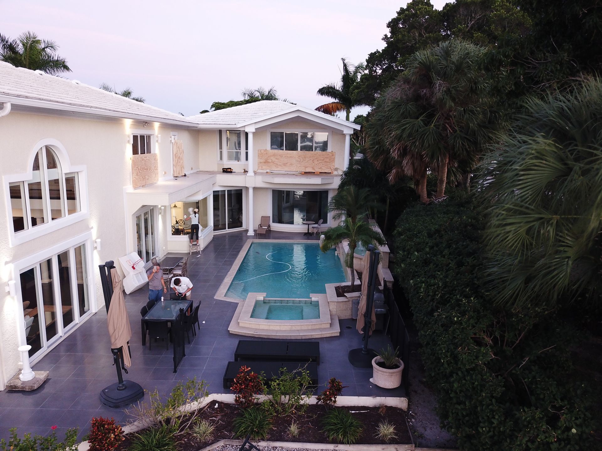An aerial view of a large house with a swimming pool