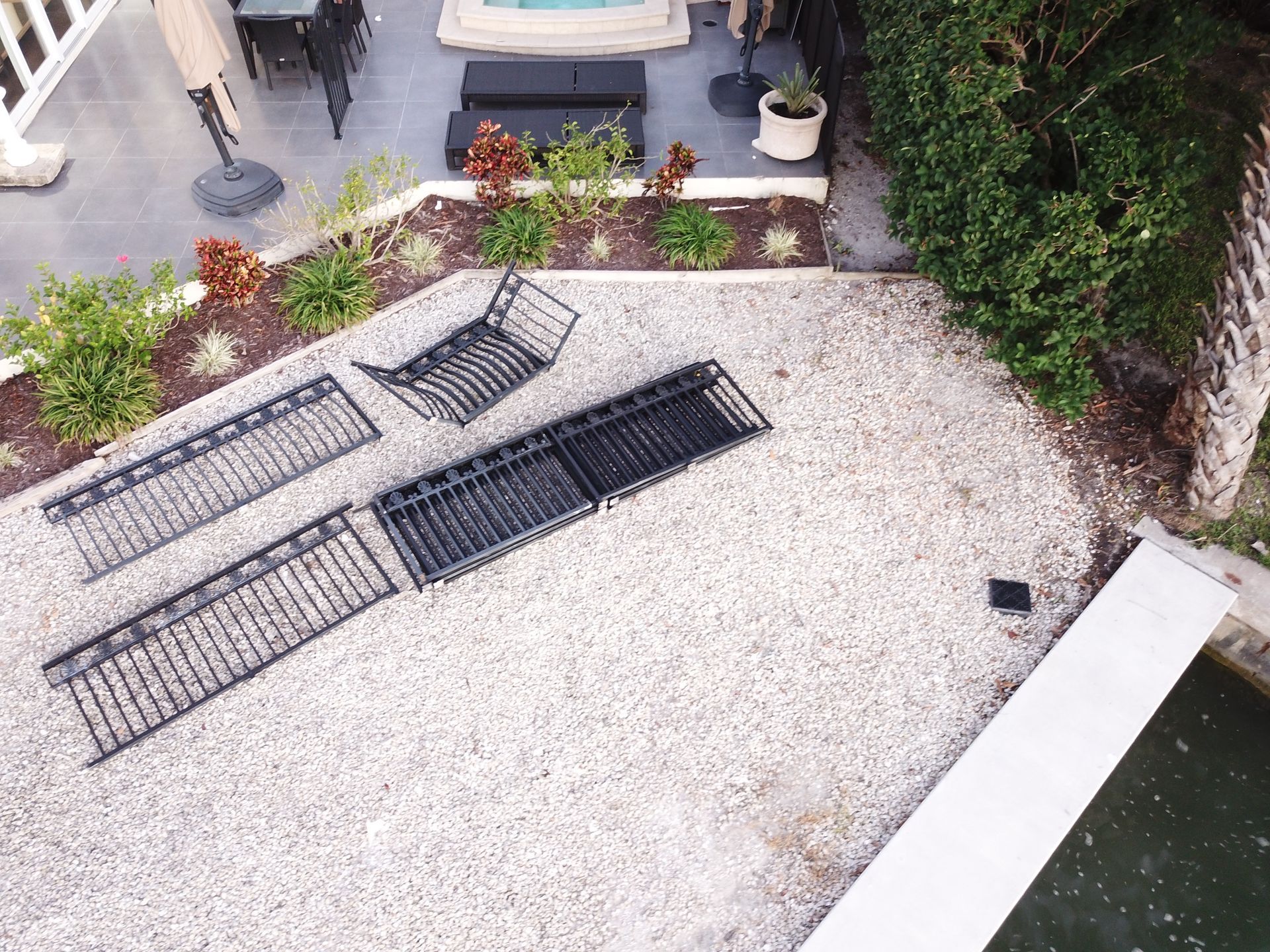 An aerial view of a patio with chairs and a pool