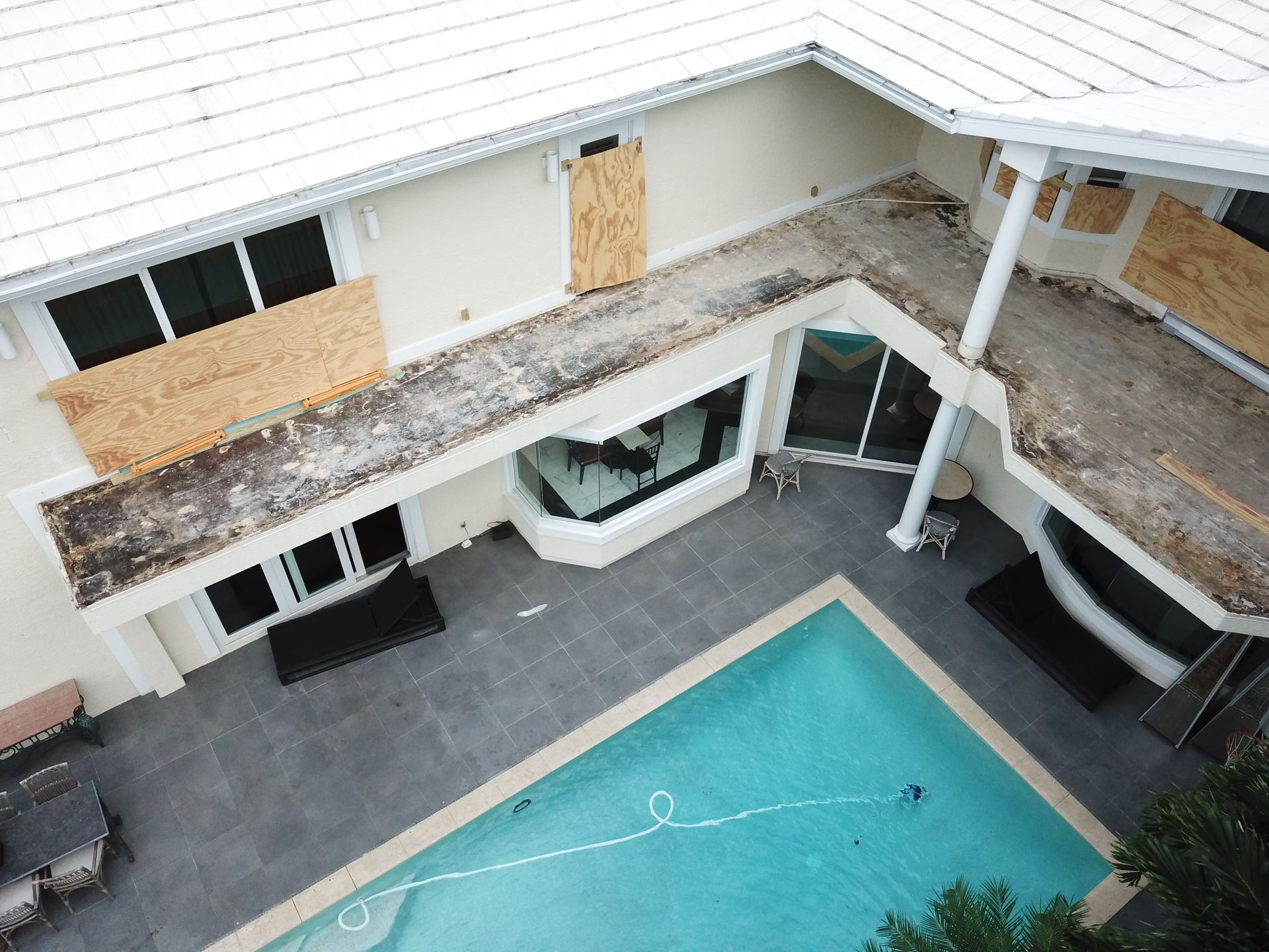 An aerial view of a house with a swimming pool