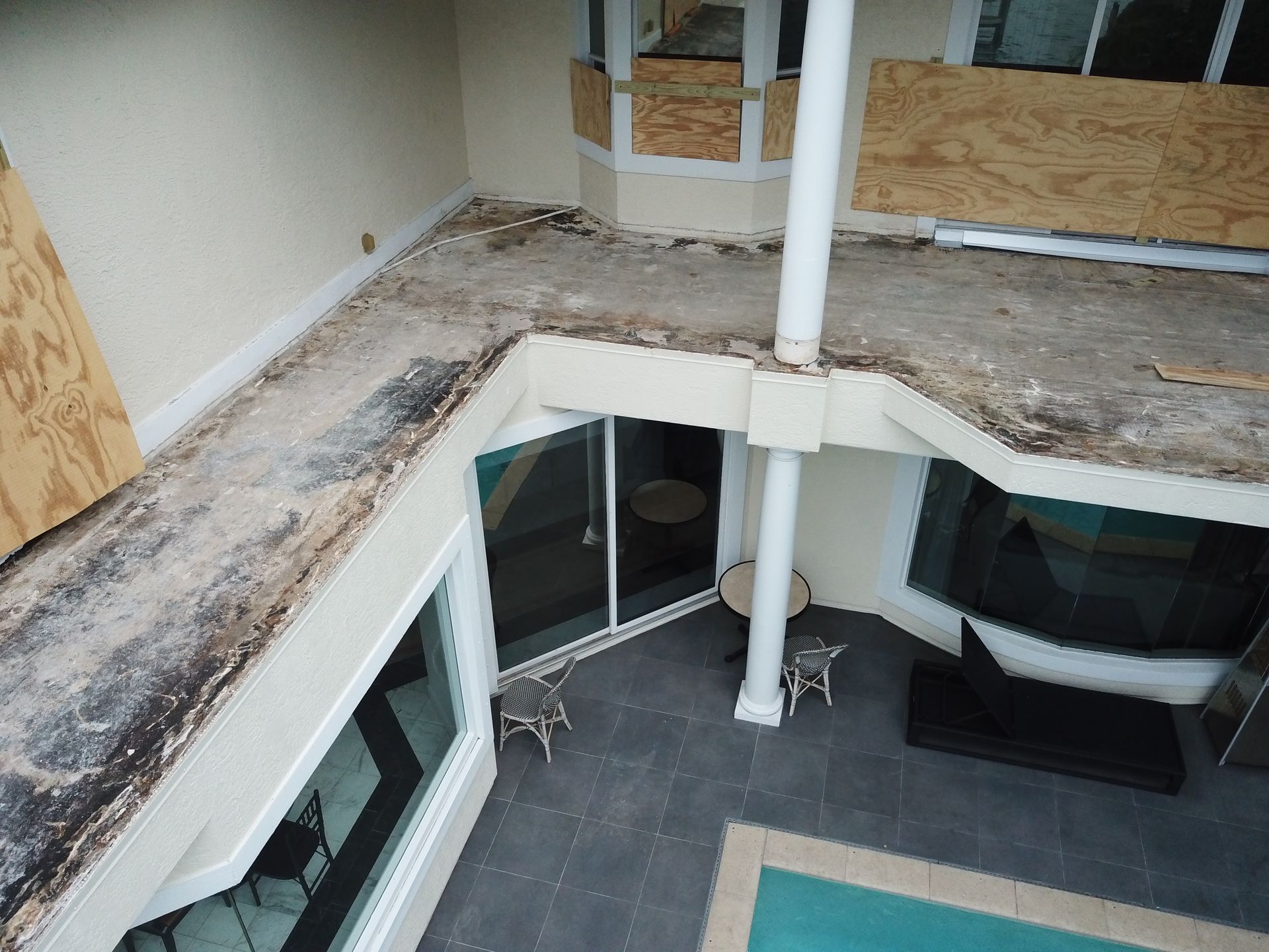 An aerial view of a house with a swimming pool