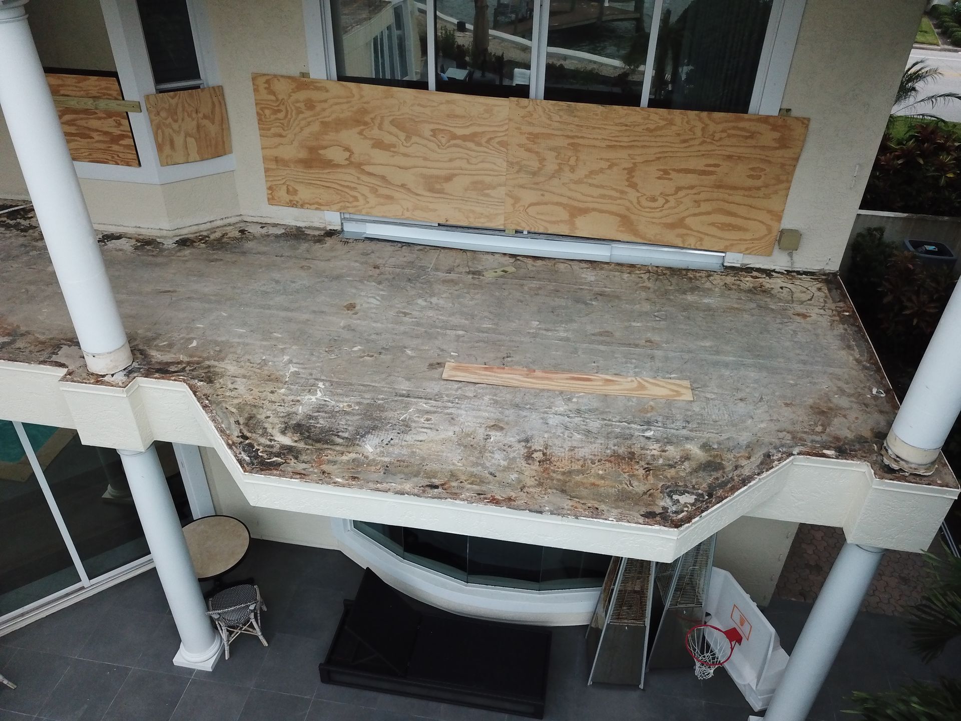 An aerial view of a house with a broken roof