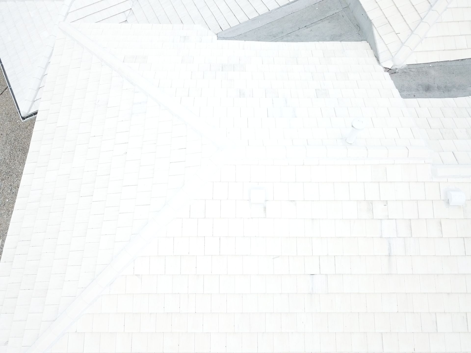 An aerial view of a white brick roof.
