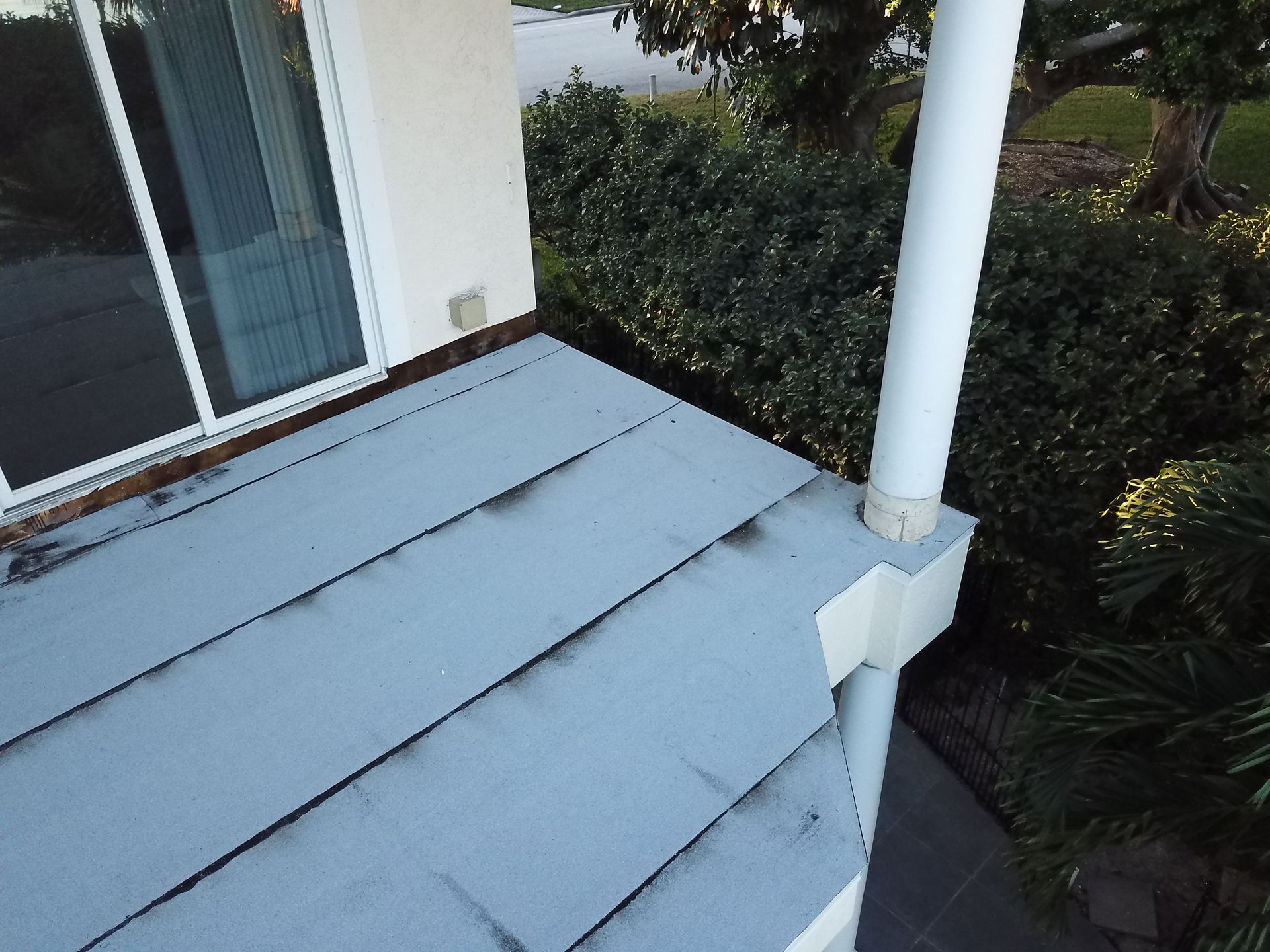An aerial view of a house with a blue roof