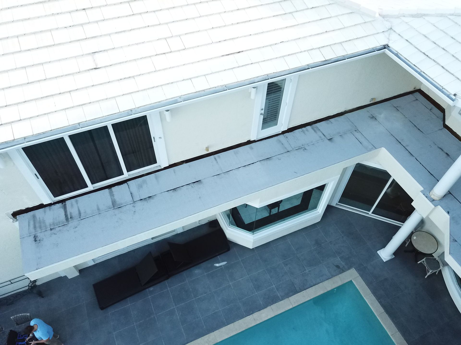 An aerial view of a house with a swimming pool