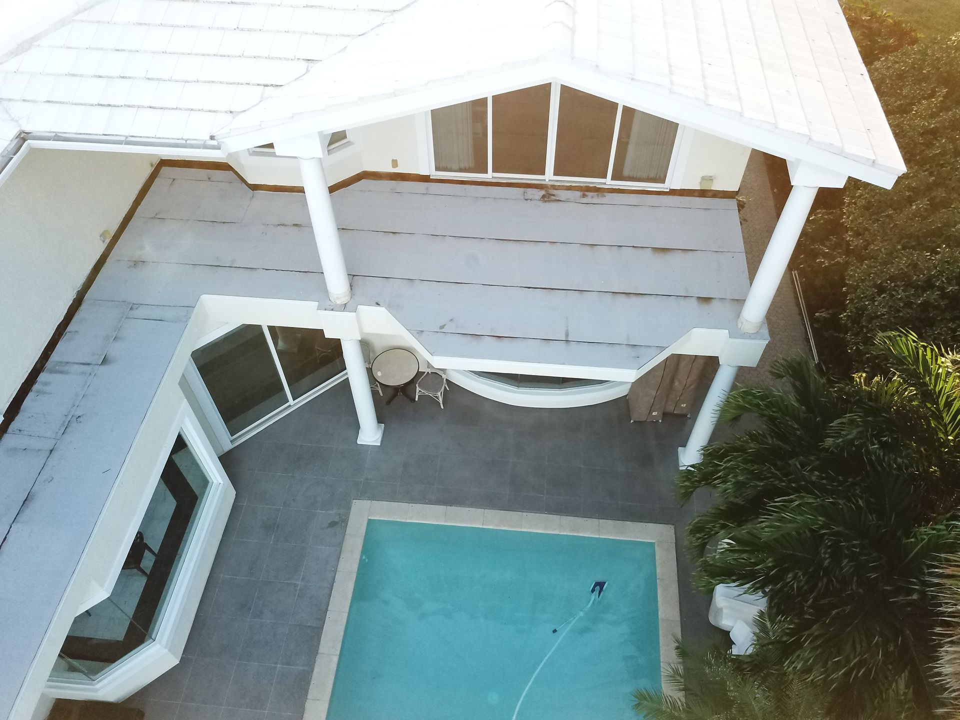 An aerial view of a house with a swimming pool