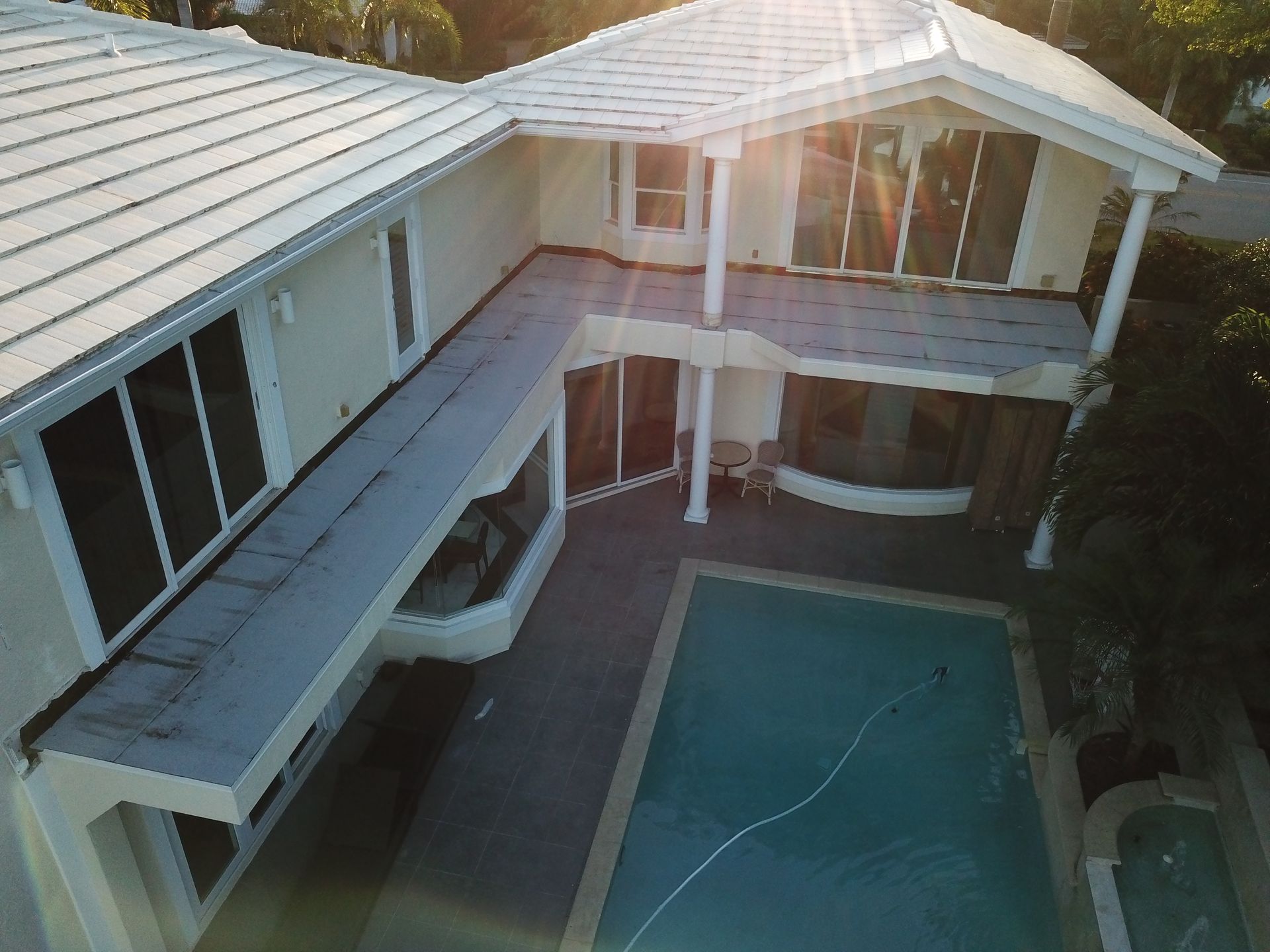 An aerial view of a large house with a swimming pool