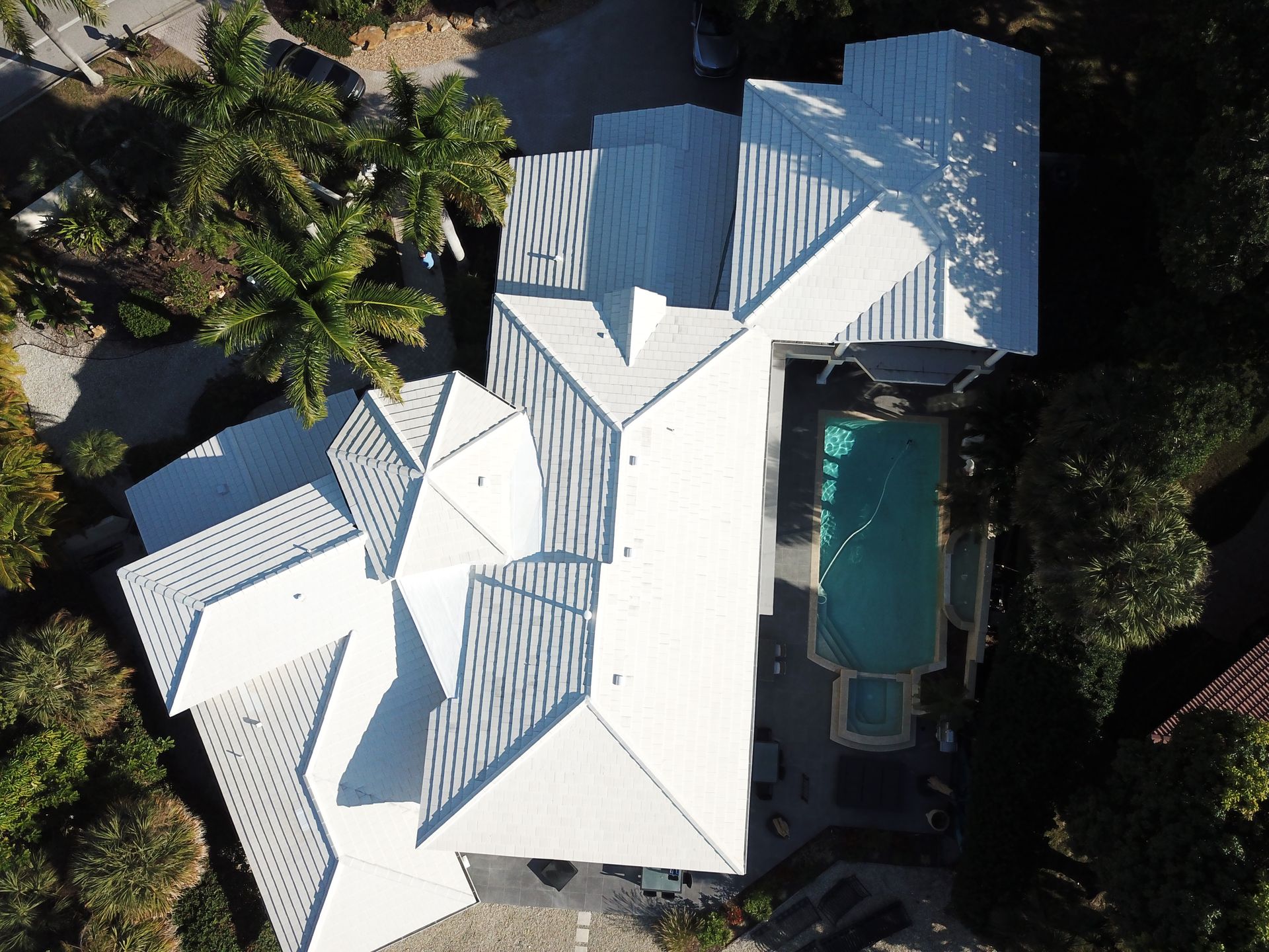 An aerial view of a house with a swimming pool