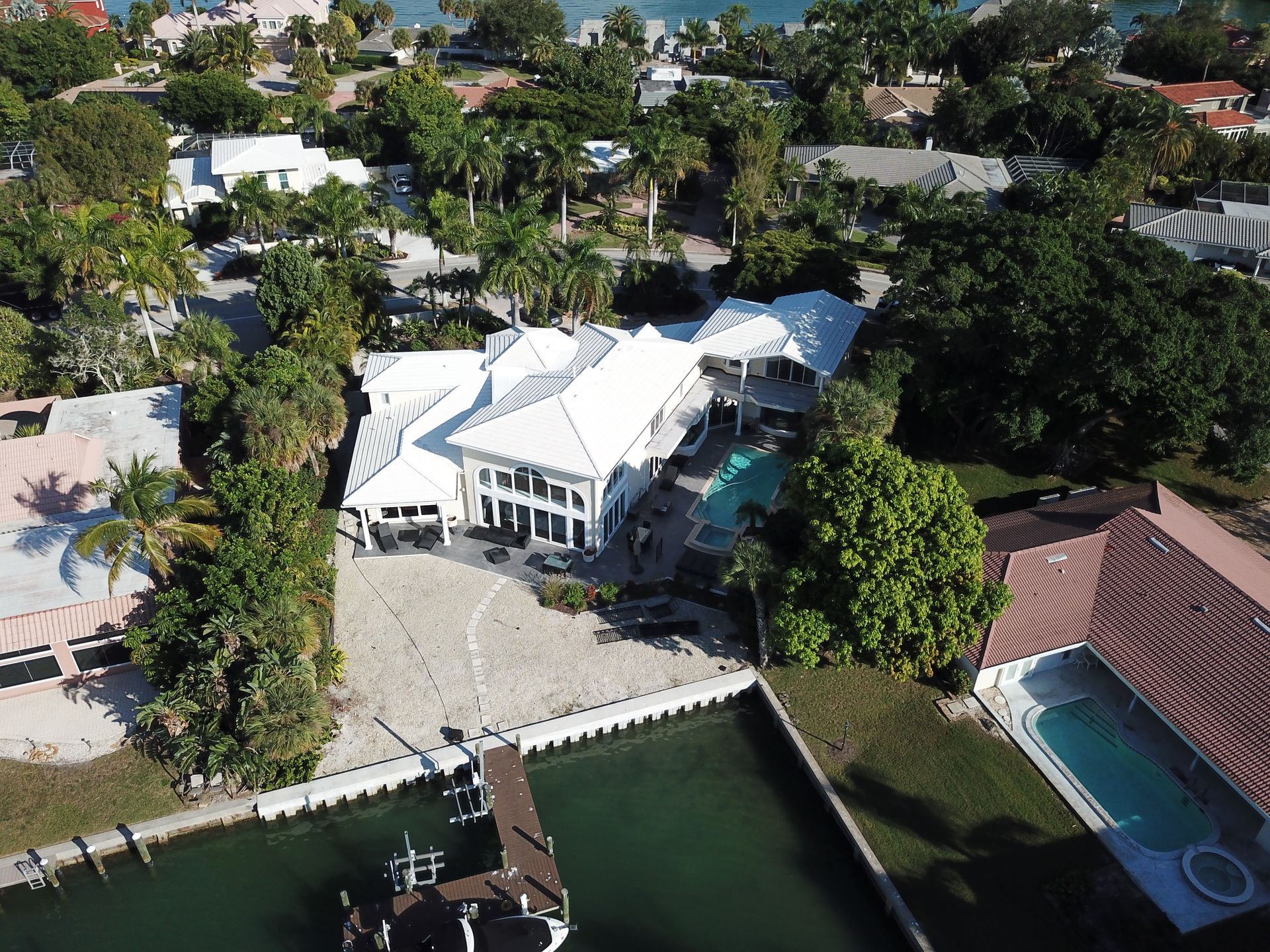 An aerial view of a large house with a pool
